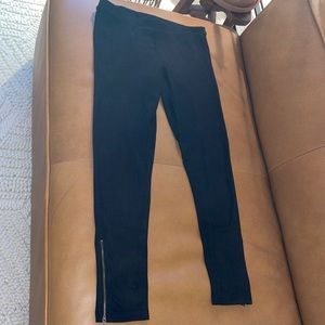 Bought from a little boutique, black suede leggings, gold zipper on both legs.